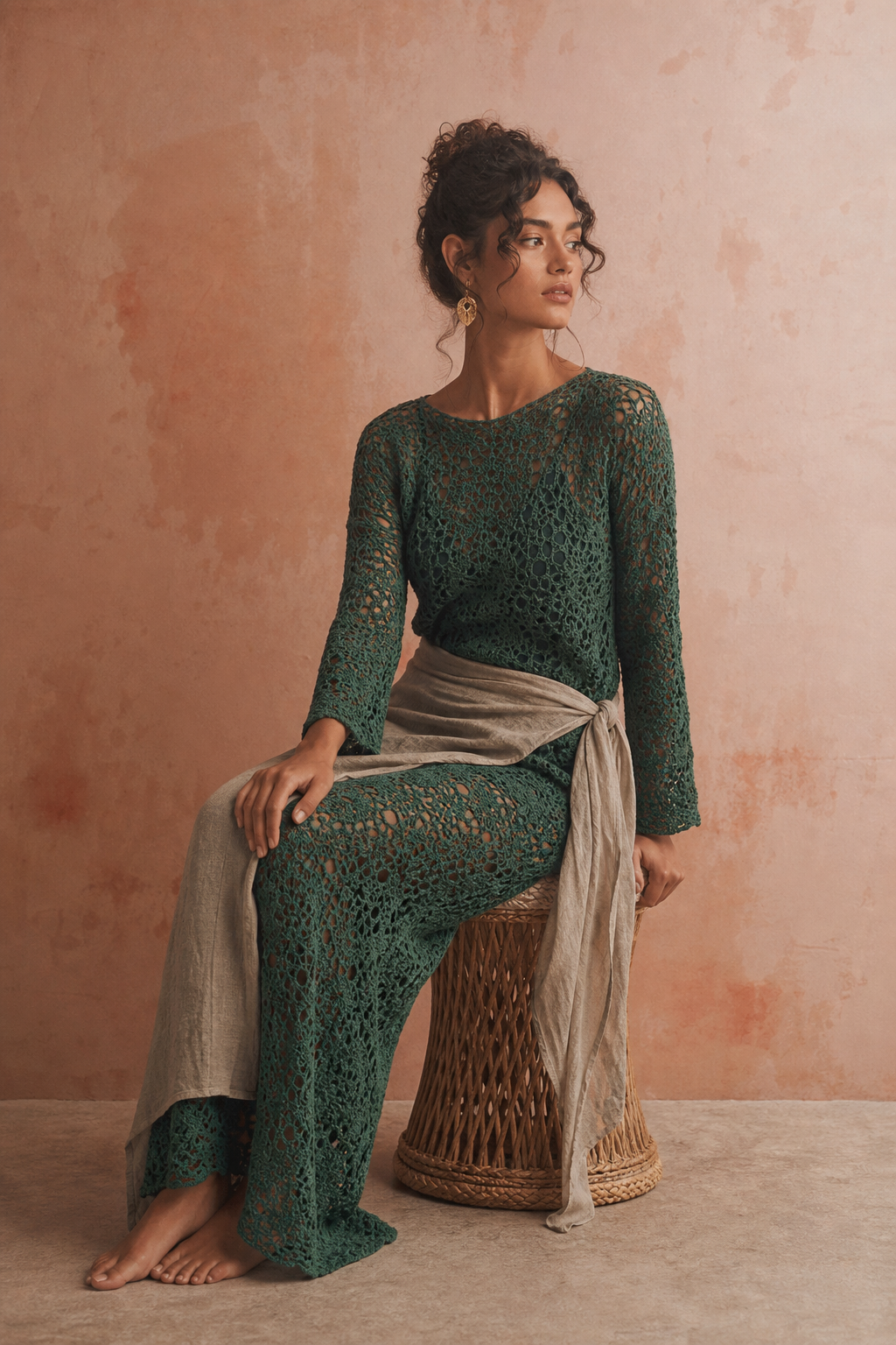 Woman in a long green hand-crocheted beach dress with a linen wrap
